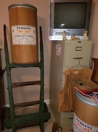 Vintage grain hand trucks, cardboard Gulf Perkins barrels, metal filing cabinet, television/DVD/VHS combo. 