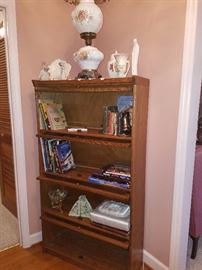 Lawyer's book case, hurricane lamp, Hull vase, Hummel praying lady, extensive book collection including autographed copies & first edition books. 