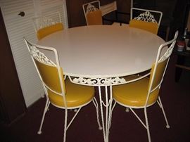 Retro wrought iron kitchen or patio table and chairs.