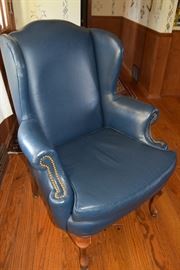 Blue leather highback chair with brass detailing studs