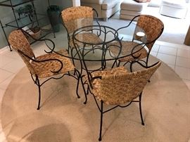 Ornate iron, glass and natural woven chairs