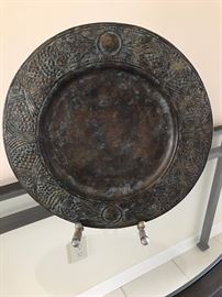 Metal decorative plate on display stand