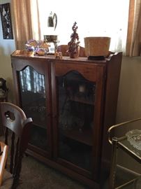 A vintage glass front display cabinet with lots of goodies inside!