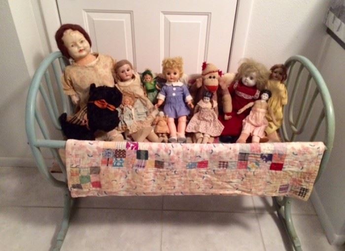Family crib dates back to pre-1877, used to transport the children from Illinois to Missouri. Here, it's filled with old dolls