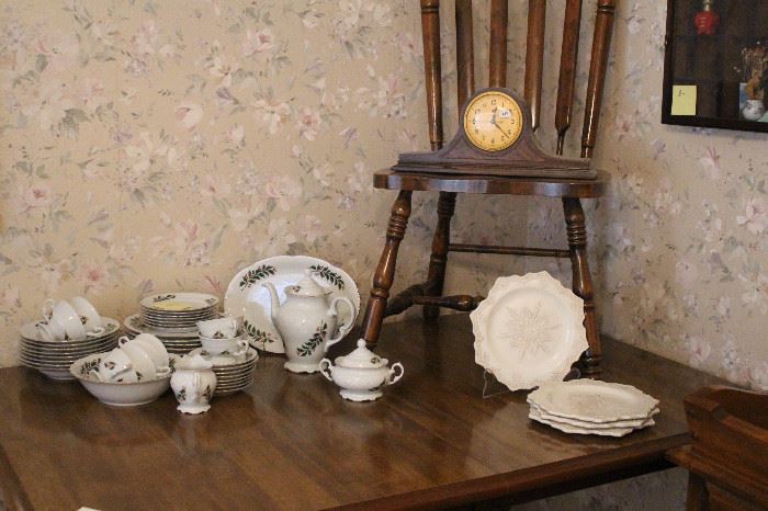 Christmas china, old clock and heavy table that comes with four chairs.  