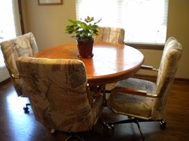 Kitchen table with leaf and 6 chairs(2 are oversized) on castors. This is a Clawfoot table with beautiful carved accents