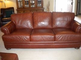 Leather Sofa/couch, reclining chair and ottoman. Leather chair in corner, china cabinet