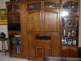 Entertainment cabinet lighted glass front, slide out spaces for dvd/vhs/cd's