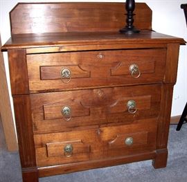               Antique three drawer chest has back splash 