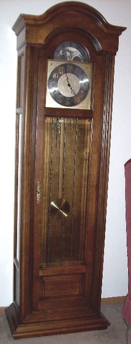 Howard Miller Grandfather clock has day/night moving dial.  Perfect condition!