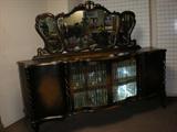 Intricately carved buffet. 8' Wide, 42.5" Tall. Beveled mirror 33" Tall and 4 inch glass panes across front. Rear legs are floating. One of a kind.