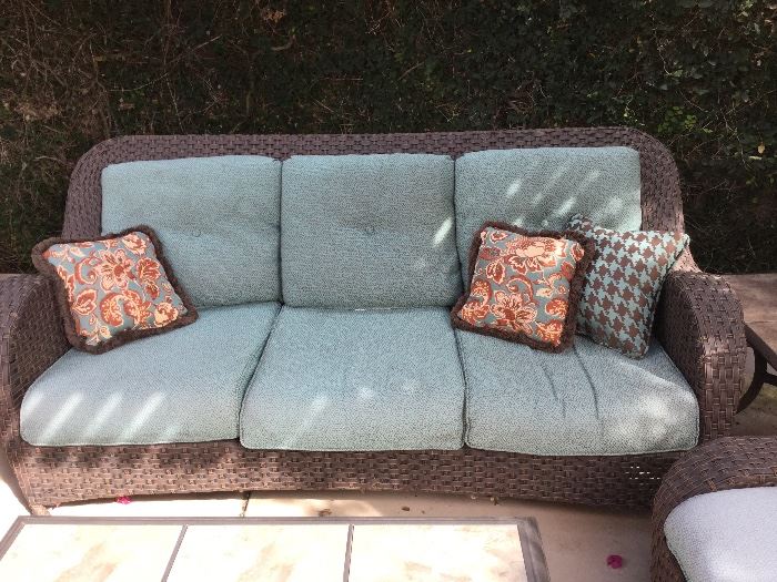 Patio sofa, matches chairs and ottomans and large coffee table inside from the Martha Stewart collection