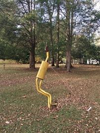 Quirky lawn ornament made from a muffler & found wood