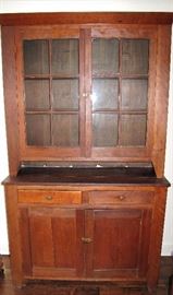 Nice two piece stepback cupboard, original wavy glass.