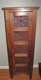 Repro cabinet with tins in door.