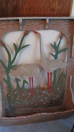 Wall rack with cut out scene.