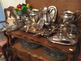 Large selection of silver plate serving pieces, large crystal platters, small serving table