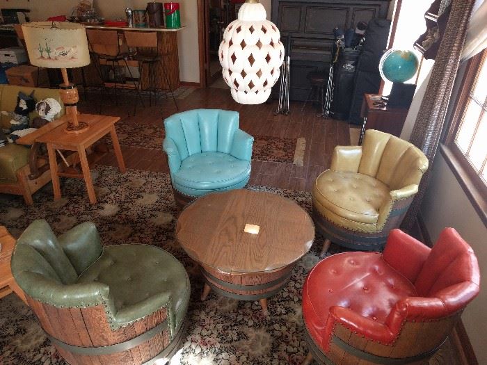 WOW! What a find! A complete set of 1960's yippee-yi- yo barrel furniture, by the San Hygene Furniture Mfg. Co., Akron, OH.                                                                  There's even a postage stamp sticker on the tag, stating Commonwealth of PA, Dept. of Labor and Industry, Harrisburg.                                                     Where in the world would you ever find a swivel barrel chair, each in the hottest earth tone naugahyde colors available? The glass-topped barrel coffee table is also a lazy susan.                                                                        You gotta hand it to those Texans for coming up with such a design jewel.                                                                  Dig the hanging, opium den pendant lamp!