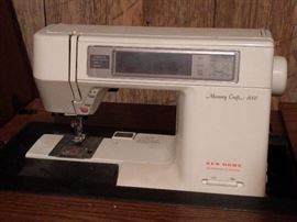 Fancy Memory Craft 8000 sewing machine, in a nice (HEAVY) wooden cabinet.
