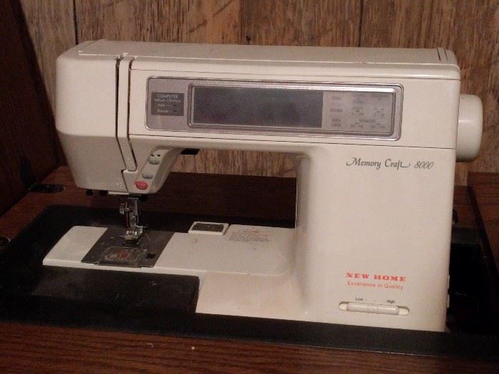 Fancy Memory Craft 8000 sewing machine, in a nice (HEAVY) wooden cabinet.