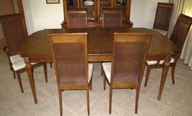 Dining Room Table In a Traditional Style All Wood in the original "Crete Wheat" Factory Finish. 4-Cane Back Side Chairs and 2 Arm Chairs