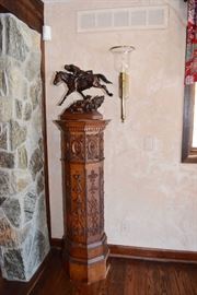 Bronze "Elusive as the Wind" by Susan Kliewer on top of an antique carved wood column.