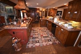 Gourmet Kitchen Complete with Leather Nailhead Hightop Chairs, Hammered Copper Hood Vent, Weathered Brass Horse Head Pot Rack and Gourmet Cookware