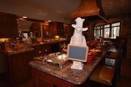 Gourmet Kitchen Complete with Leather Nailhead Hightop Chairs, Hammered Copper Hood Vent, Weathered Brass Horse Head Pot Rack and Gourmet Cookware
