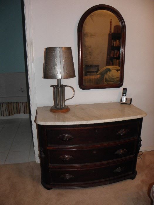 Marble top three drawer dresser, punch tin lamp, arched top mahogany silvered mirror
