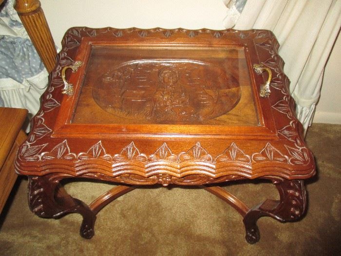Ornate table with center carving, removable glass serving tray.