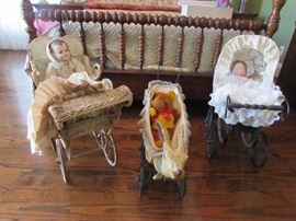 Vintage doll carriages.  Doll on the right is a working music box as is the teddy bear in the center.