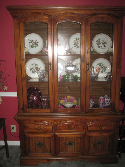 Another lighted china cabinet with collectible bird plates