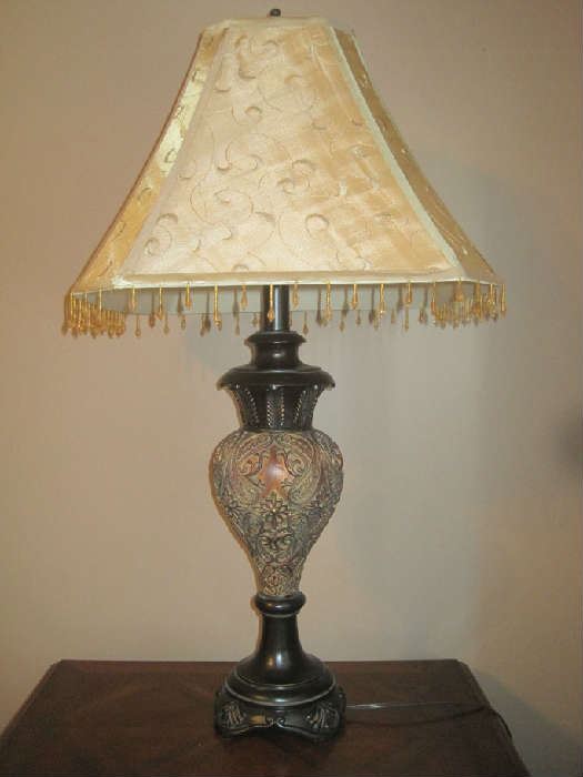 One of a pair of table lamps on end tables in living room