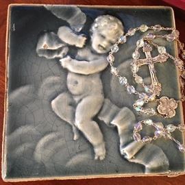 Love this majolica tile. To the right is a sterling silver and crystal rosary. One of many that will be for sale.