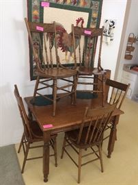 Oak table with 2 leaves & 5 chairs (priced separately)