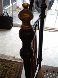 Antique claw foot oak table with black accent and four metal framed chairs with wicker seating