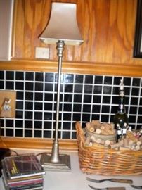 basket, wine corks and table lamp