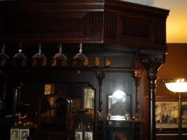 Antique/Vintage Tavern/pub bar....includes front and back bar with mirror and overhead for holding glasses and lighting. Overhead connects the front and back.