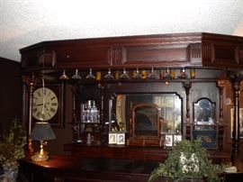 Antique/Vintage Tavern/pub bar....includes front and back bar with mirror and overhead for holding glasses and lighting. Overhead connects the front and back.