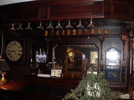 Antique/Vintage Tavern/pub bar....includes front and back bar with mirror and overhead for holding glasses and lighting. Overhead connects the front and back.