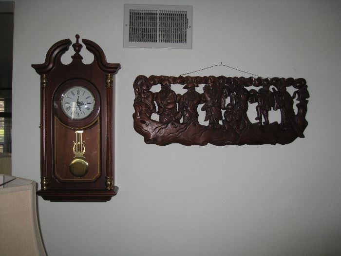 Wall clock and hand carved oriental wood piece
