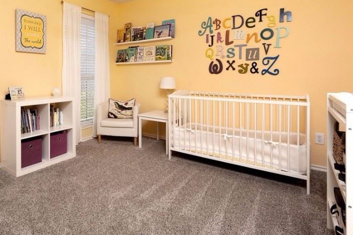 Baby nursery. Convertible crib. 2 changing tables. small tables and storage.  Table, chair & lamp. Unique wall decor