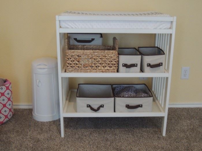 one of 2 changing tables.  Changing pad with custom cover.  Many storage baskets. Diaper pail