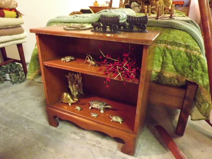 Maple bookcase; brass turtles, cricket, and crab; cast iron covered wagon bookends