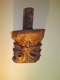 Hand-crafted wooden wall decor, man smoking pipe
