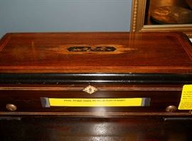 inlaid case of vintage cylinder music box