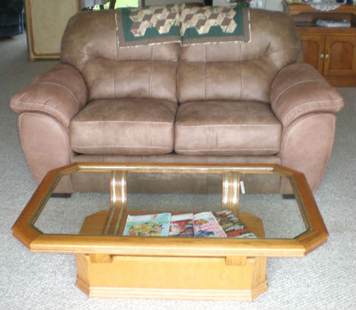 Beautiful overstuffed loveseat, only one year old, like new condition, and glass top coffee table.