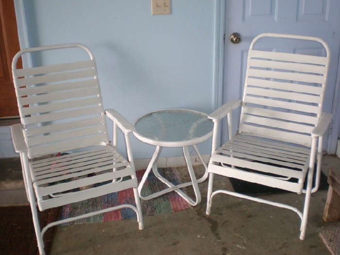 Two folding chairs and small table.