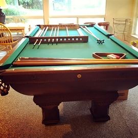 Antique (1911) Brunswick pool table and accessories.