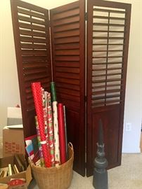 Privacy divider with plantation shutters, christmas wrapping paper.